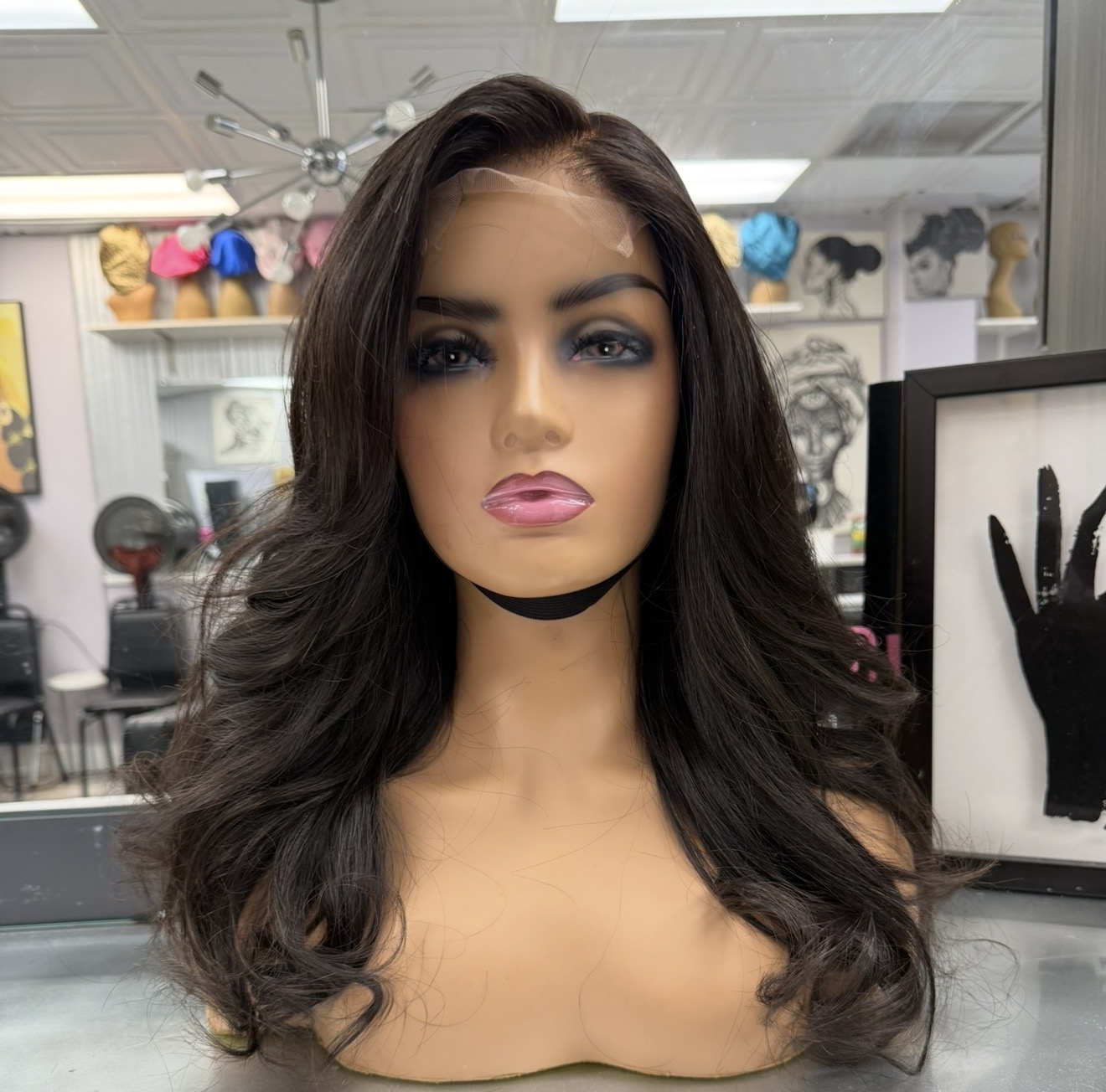Long wavy lace-front wig on mannequin